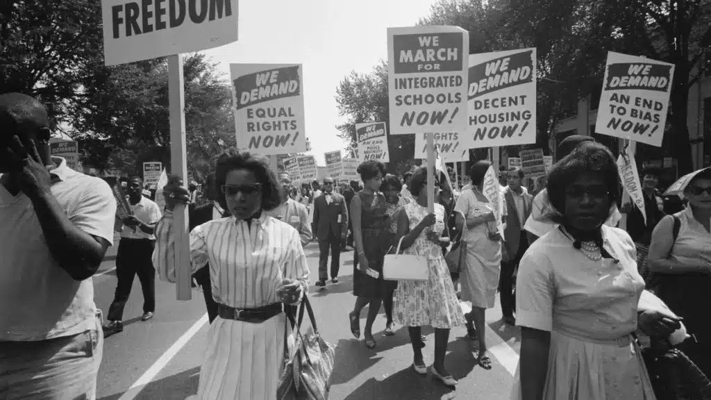Photograph showing a procession of African Americans carrying signs for equal rights during the 1963 Civil Rights March on Washington, D.C.